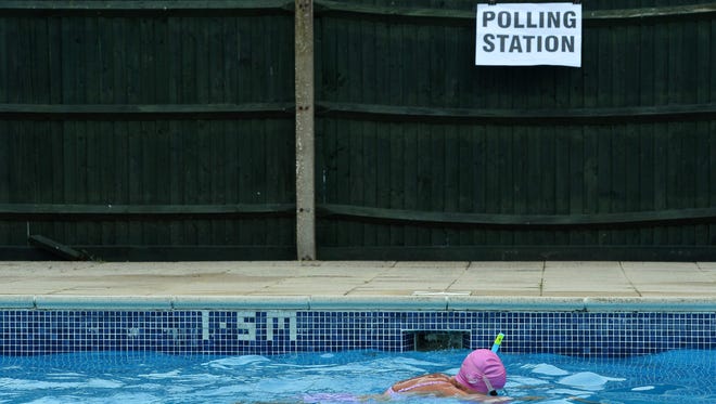 Voter Anne Whitman swims at Arundel Lido, set up as a polling station, in Arundel, southern England, as Britain holds a referendum on whether to stay or leave the European Union.