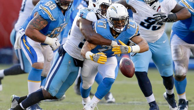 San Diego Chargers running back Kenneth Farrow (27) can't hold on to the pass as he is hit by Tennessee Titans inside linebacker Avery Williamson during the second half of an NFL football game Sunday, Nov. 6, 2016, in San Diego.