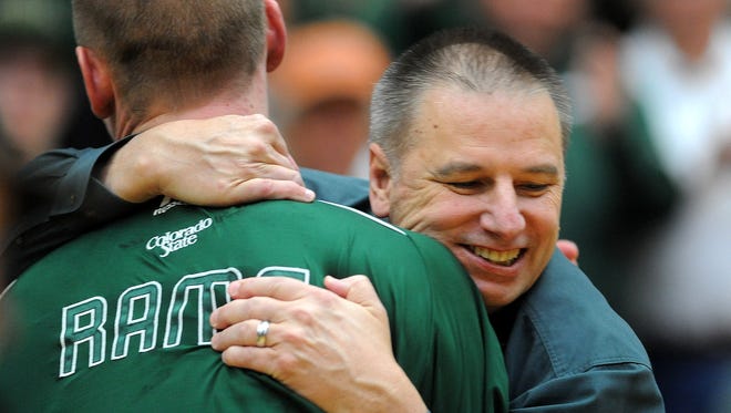 CSU basketball coach Larry Eustachy jumps up to embrace Colton Iverson as the seniors are honored in 2013.