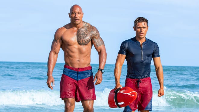 Dwayne Johnson, left, and Zac Efron are hard-bodied lifesavers in the comedy 'Baywatch.'