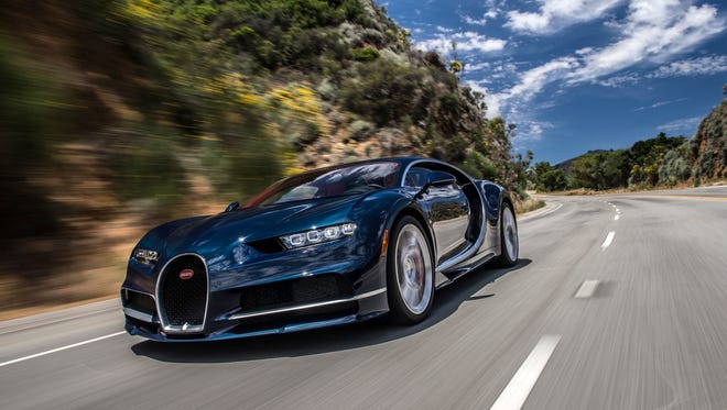 The Bugatti Chiron driving on a winding road.