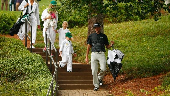 Bubba Watson walks with his wife and children during the Par 3 Contest.