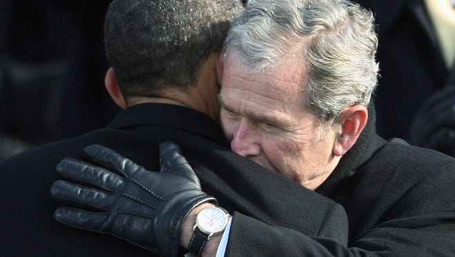 Former President George W. Bush hugs newly sworn President Barack Obama at the U.S. Capitol on Jan. 20, 2009.