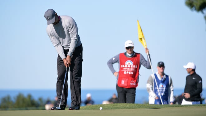 Tiger Woods putts on the 11th green during the second round of the Farmers Insurance Open golf tournament at Torrey Pines Municipal Golf Course - North Co.