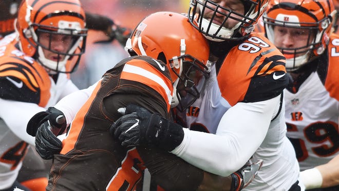 Cincinnati Bengals defensive end Margus Hunt (99) tackles Cleveland Browns wide receiver Ricardo Louis (80) during the first quarter at FirstEnergy Stadium.