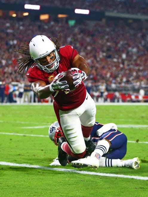 Arizona Cardinals wide receiver Larry Fitzgerald (11) dives into the end zone to score a touchdown against the New England Patriots.