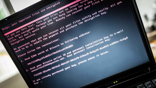 epaselect epa06053537 A laptop screen displays a message after it was infected with ransomware during a worldwide cyberattack, in Geldrop, Netherlands, 27 June 2017 (issued 28 June 2017).  EPA/ROB ENGELAAR ORG XMIT: 52093547