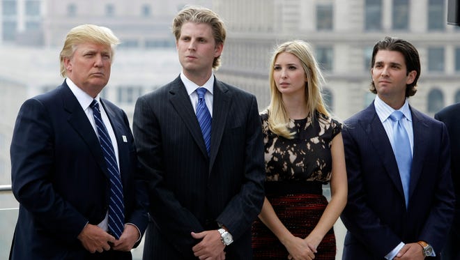 Donald Trump waits to be announced with his children, from left, Eric, Ivanka and Donald Jr., during festivities for the Trump International Hotel and Tower in Chicago on Sept. 24, 2008.