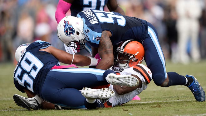 Browns wide receiver Andrew Hawkins (16) gets stopped by Titans inside linebacker Wesley Woodyard (59) and Titans inside linebacker Avery Williamson (54) at Nissan Stadium Sunday, Oct. 16, 2016, in Nashville, Tenn.