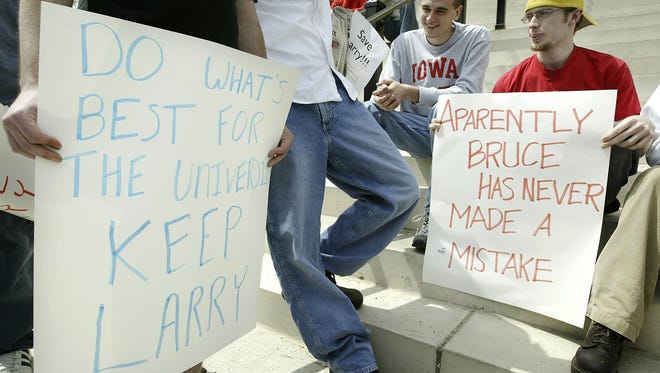 Ward Wester, right, a freshman at Iowa State University holds a sign supporting men's basketball coach Larry Eustachy at a rally attended by approximately 30 students outside of Beardshear Hall on the ISU campus in Ames, Iowa, Thursday, May 1, 2003.