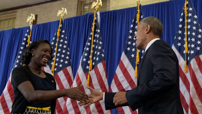 Obama shakes hands with Benjamin Banneker Academic High School senior Ifunaya Azikiwe during his visit to the school in Washington on Oct. 17, 2016, where he highlighted the steady increase in graduation rates.