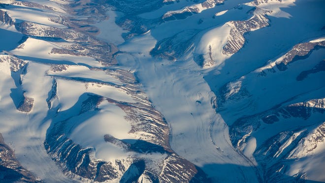 A beautiful glacier flows between mountains in far eastern Canada, seen aboard a Norwegian Air 737 MAX delivery flight on June 29, 2017.