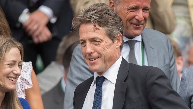 Hugh Grant attends the men's final between Marin Cilic and Roger Federer on day thirteen.