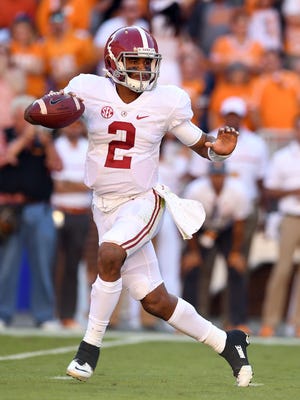 Alabama Crimson Tide quarterback Jalen Hurts (2) drops back to pass under pressure from the Tennessee Volunteers defense during the first quarter at Neyland Stadium.