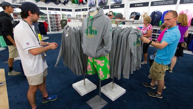 Fans peruse U.S. Open Golf Championship souvenir apparel.