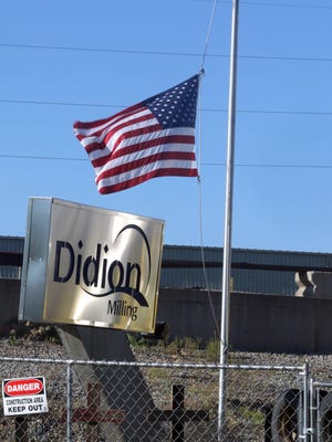 The flag flying at half mast in front of the rubble left from a May 31 explosion at a corn mill plant at the Didion Milling complex in Cambria has been raised to full staff after the last person injured in the blast was released from the hospital. Five workers died as a result of the explosion.