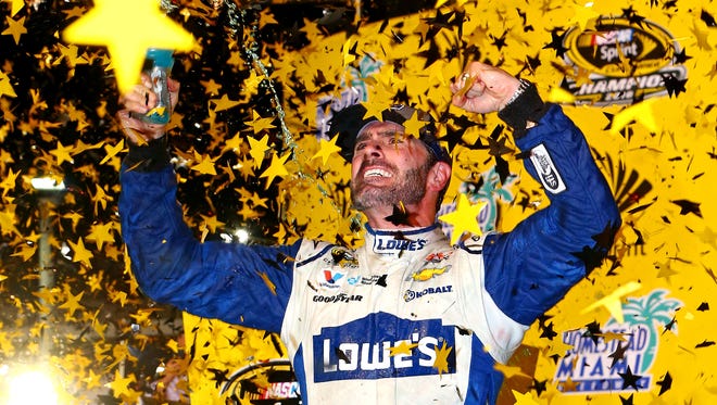 Nov 20: Jimmie Johnson (48) celebrate winning the NASCAR Sprint Cup championship after the Ford Ecoboost 400 at Homestead-Miami Speedway.