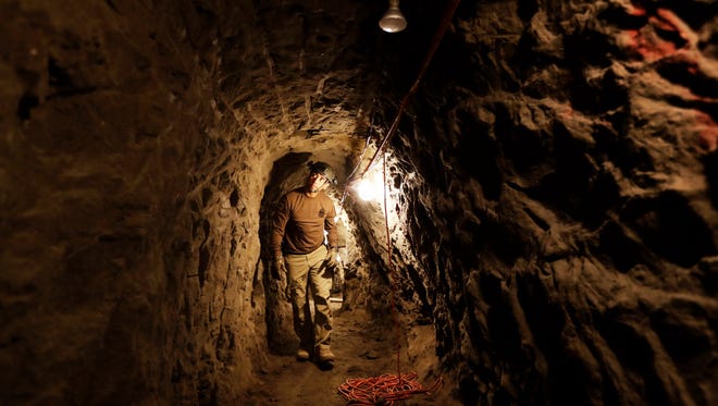 In this March 6, 2017, photo, a member of the Border Patrol's Border Tunnel Entry Team walks in a tunnel in San Diego that spans the border between the California city and Tijuana, Mexico. Team members are known in the Border Patrol as "tunnel rats" — agents who go in the clandestine passages that have proliferated on the U.S.-Mexico border over the last 20 years to smuggle drugs.