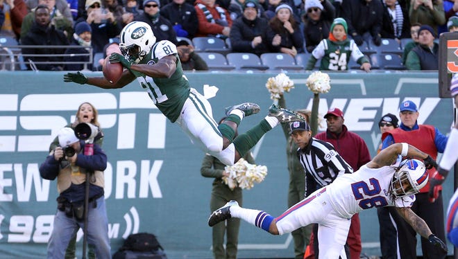 New York Jets wide receiver Quincy Enunwa (81) hurdles Buffalo Bills corner back Ronald Darby (28) for a first down during the second quarter at MetLife Stadium.