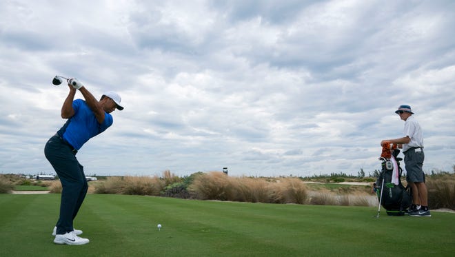 Tiger Woods hits his tee shot on the ninth hole during Monday's practice round of the Hero World Challenge.