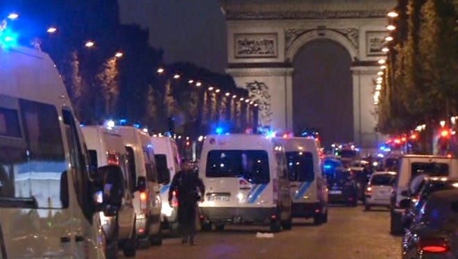 In this image made from video, police attend the scene after a shooting incident on the Champs-Elysees in Paris, Thursday April 20, 2017.