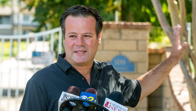 Robby Gordon makes a statement to members of the media gathered outside his home in Orange, Calif.
