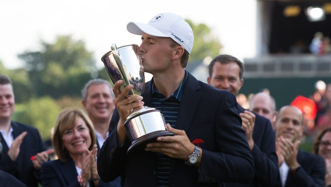Jordan Spieth kisses the championship trophy after a victory in the first playoff hole during the final round of the Travelers Championship golf tournament at TPC River Highlands on June 25.