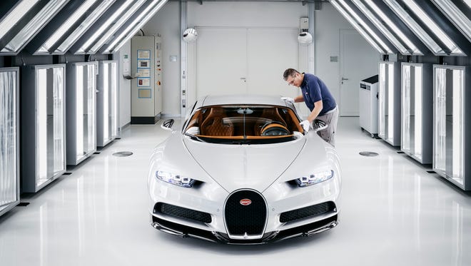 A Bugatti employee inspects a completed Chiron in case it needs to be buffed or corrected.