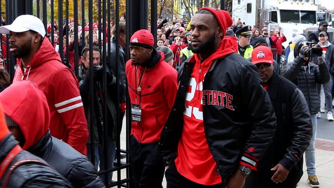 Ohio State fan LeBron James, of the Cleveland Cavaliers, arrives with teammates at Ohio Stadium in Columbus, Ohio before the Michigan game Saturday, Nov. 26, 2016.