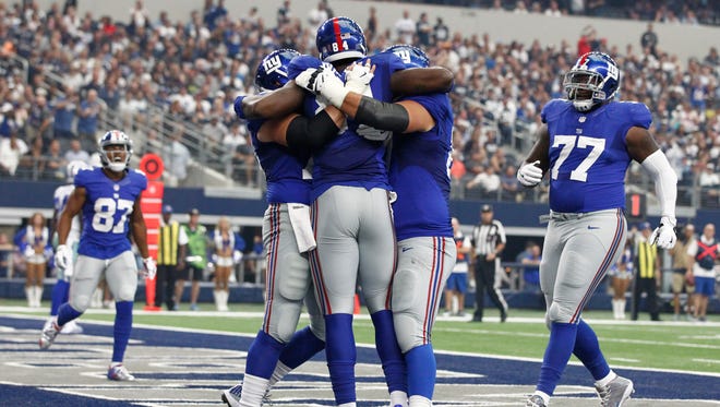 New York Giants tight end Larry Donnell (84) celebrates a touchdown with his teammates in the second quarter against the Dallas Cowboys at AT&T Stadium.