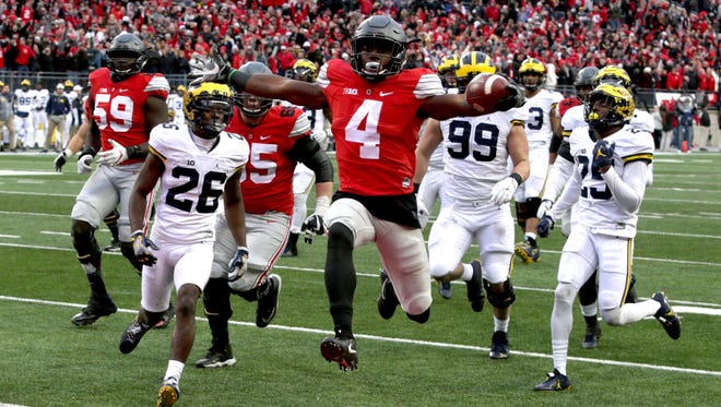 Ohio State #4 Curtis Samuel jumps for joy and into the end zone in the second overtime for Ohio State's 30-27 win over Michigan at Ohio Stadium in Columbus, Ohio on Saturday, November 26, 2016.