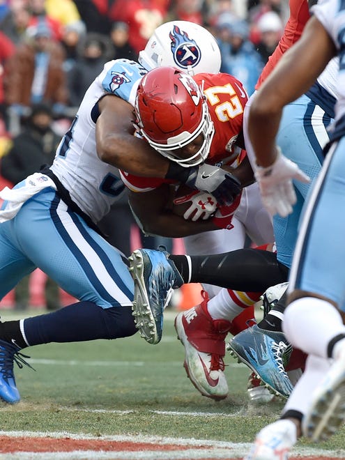 Chiefs running back Kareem Hunt (27) goes in for the touchdown defended by Titans linebacker Avery Williamson (54) during the first quarter at Arrowhead Stadium Saturday, Jan. 6, 2018 in Kansas City , Mo.