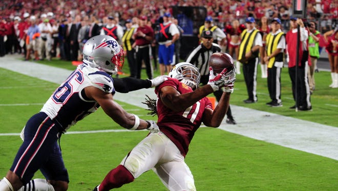 Arizona Cardinals wide receiver Larry Fitzgerald (11) catches a touchdown pass, the 100th of his career, against the New England Patriots.