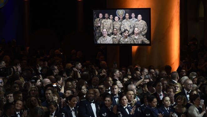 Members of the U.S. Armed Forces wait for President Donald Trump and First Lady Melania Trump during the Salute to Our Armed Services Inaugural Ball at the National Building Museum in Washington.