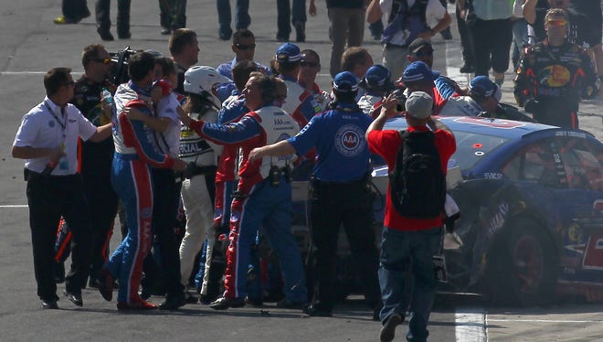 An altercation on track with Tony Stewart led crew members to hold back Joey Logano after the NASCAR Sprint Cup Series Auto Club 400  at Auto Club Speedway on March 24, 2013 in Fontana, California.