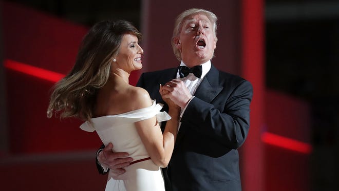 President Donald Trump sings to the song "My Way" while dancing with first lady Melania Trump during the inaugural Liberty Ball at the Washington Convention Center  in Washington.