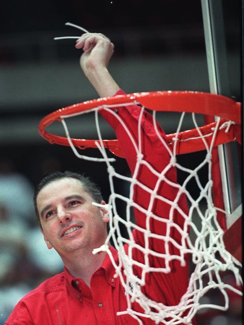 - -AMES--Larry Eustachy holds a piece of the net from Hilton Coliseum as he celebrates the men's basketball team's Big 12 Conference championship Sunday. Register photo by Mary Chind (March 6, 2000)- -Caption: Men's coach Larry Eustachy enjoys the net cutting at Hilton Coliseum.- -Ran in B & Wh
