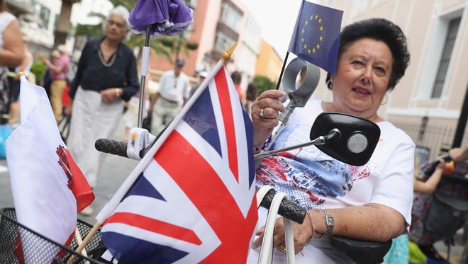 A woman in a wheelchair with British and European Union flags shows her support for the United Kingdom to remain in the European Union on the day of the EU Referendum in Gibraltar. The United Kingdom and its dependent territories went to the polls to decide whether or not the United Kingdom will remain in the European Union.