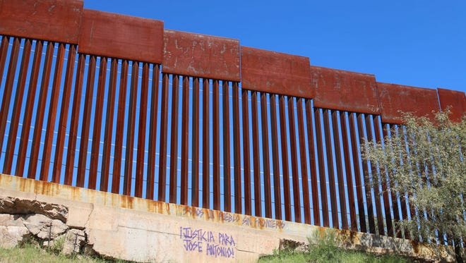 Purple graffiti with the words “justice for Jose Antonio!” marks part of the border fence on the Mexico side in 2015.
