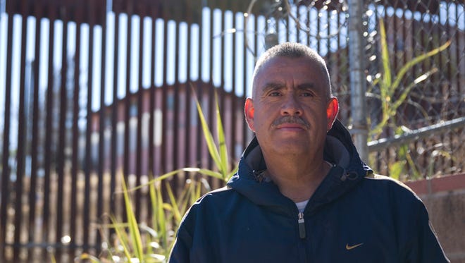 Carlos Santa Cruz, a landscaper who lives near the wall in Nogales, stands in front of the border wall on Jan. 25, 2016.