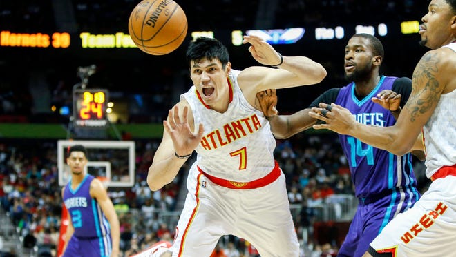 Atlanta Hawks forward Ersan Ilyasova (7) reaches for a loose ball past Charlotte Hornets forward Michael Kidd-Gilchrist (14) in the second quarter at Philips Arena.