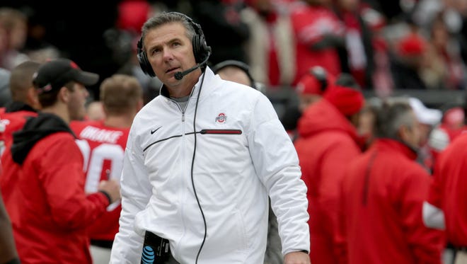 Ohio State coach Urban Meyer looks up at the scoreboard during the first half against the University of Michigan at Ohio Stadium on Saturday, Nov. 26, 2016.