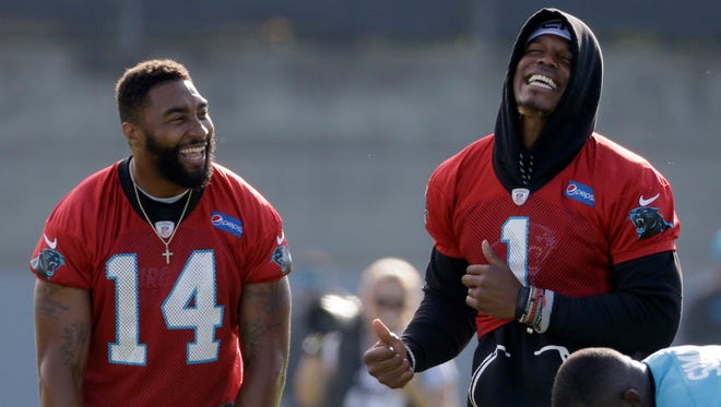 The Carolina Panthers' Cam Newton (1) dances to music as Joe Webb (14) laughs during the  team's minicamp in Charlotte.