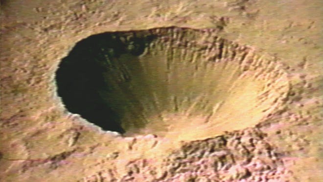 The 1,280-foot-diameter, 320-foot-deep crater created during Project Sedan atomic bomb testing is seen July 6, 1962, in this image from a U.S. Department of Energy video released in 1996. The 104-kiloton blast was one of several nuclear explosions detonated during the early years of the cold war at the Nevada Test Site, now called the Nevada National Security Site, about 125 miles northwest of Las Vegas.