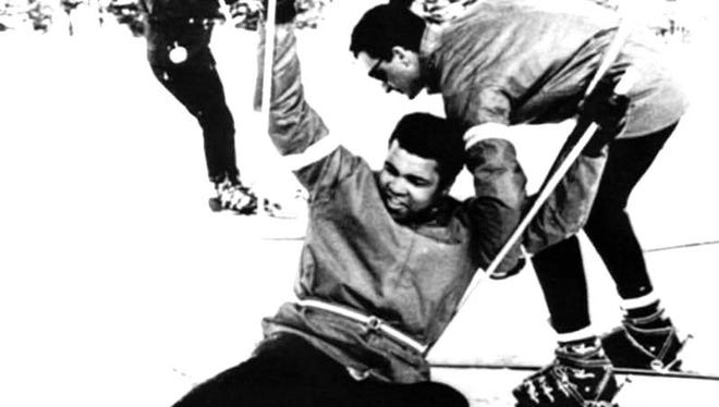 Boxer Muhammad Ali is helped up by instructor Bob Gratton after a fall during a 1970 lesson at Mount Snow in West Dover.