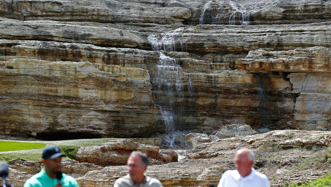 Professional golfer Tiger Woods (left) and Bass Pro Shops founder and CEO Johnny Morris (middle) answer fellow golfer Tom Lehman's questions during a press event announcing a new golf course designed by Tiger Woods with the support of Johnny Morris in Hollister, Mo. on April 18, 2017.