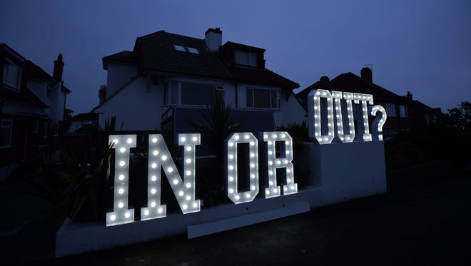 An "In or Out" sign is pictured outside a house in Hangleton, England, on June 23, 2016. Britain holds a referendum on whether to stay or leave the European Union.   Millions of Britons began voting Thursday in a bitterly-fought, knife-edge referendum that could tear up the island nation's EU membership and spark the greatest emergency of the bloc's 60-year history.