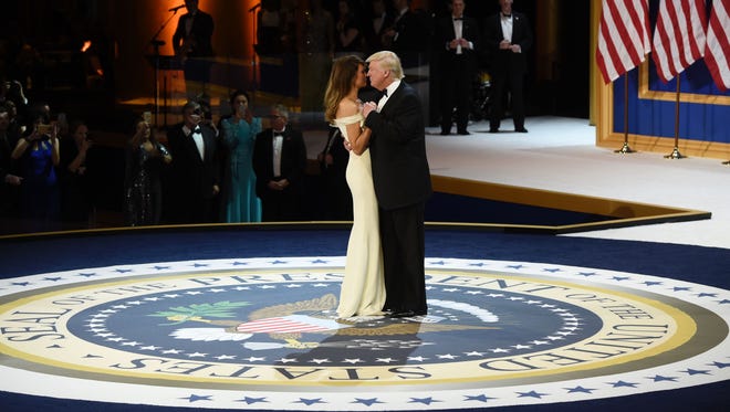 President Donald Trump and his wife First Lady Melania Trump dance on stage during A Salute To Our Armed Services Inaugural Ball at the National Building Museum in Washington.