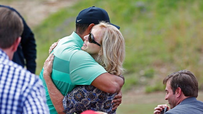 Professional golfer Tiger Woods (left) hugs Tracey Stewart, widow of Springfield-native Payne Stewart, following a press event announcing a new golf course designed by Tiger Woods with the support of Johnny Morris in Hollister, Mo. on April 18, 2017.