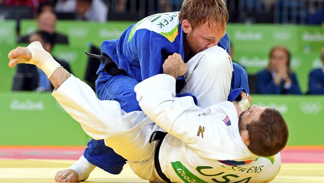 Travis Stevens of the United States, bottom, fights Robin Pacek of Sweden during men's judo 81kg round 32 in the Rio 2016 Summer Olympic Games at Carioca Arena 2.